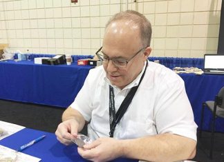 Lang examines coins at the NGC booth