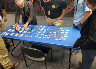 Doug Davis setting up counterfeits display